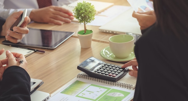 Business woman Use a calculator to calculate. Analysis of figures during the conference. 