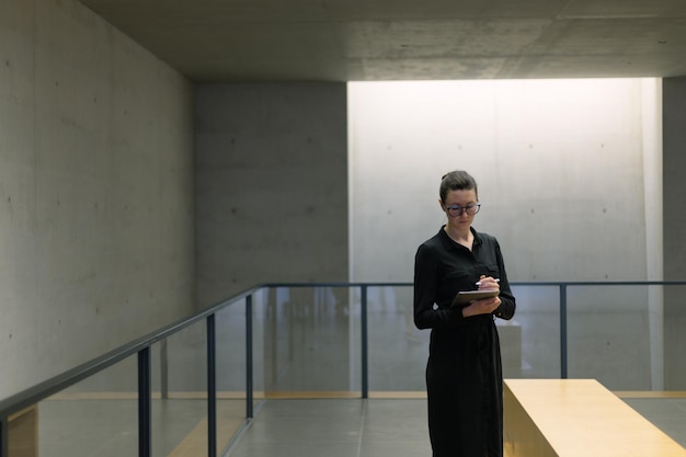 Business woman using tablet pc in minimalist office interior