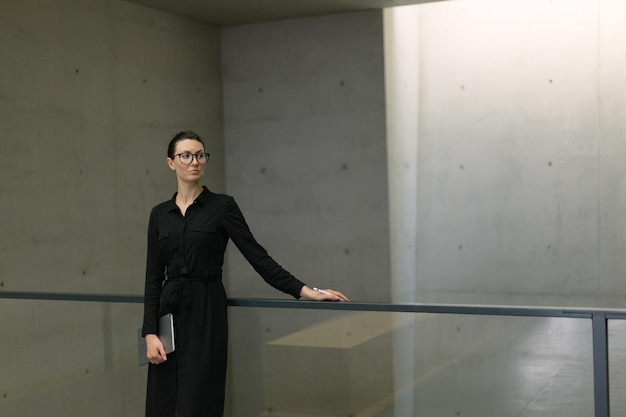 Business woman using tablet pc in minimalist office interior