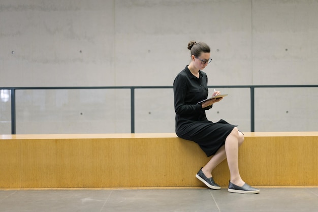 Business woman using tablet pc in minimalist office interior