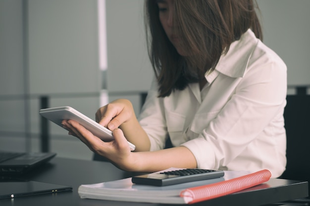 Business woman using tablet on table