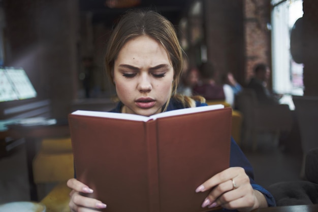 Business woman with book in hands of cafe coffee cup lifestyle