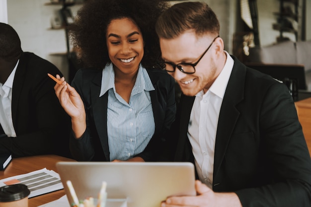 Business Woman on with Colleagues is Sitting at Table