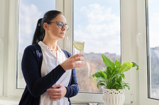 Business woman with glass of water with lemon