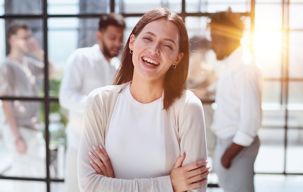 Business woman with her staff in background at office