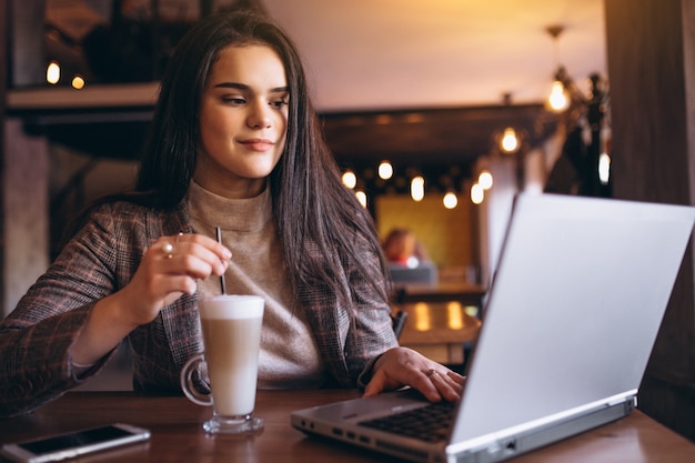 Business woman with laptop and coffee in a cafe