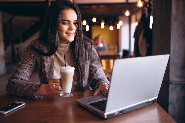 Business woman with laptop and coffee in a cafe