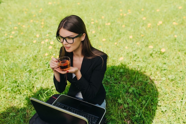 Business woman with laptop in park