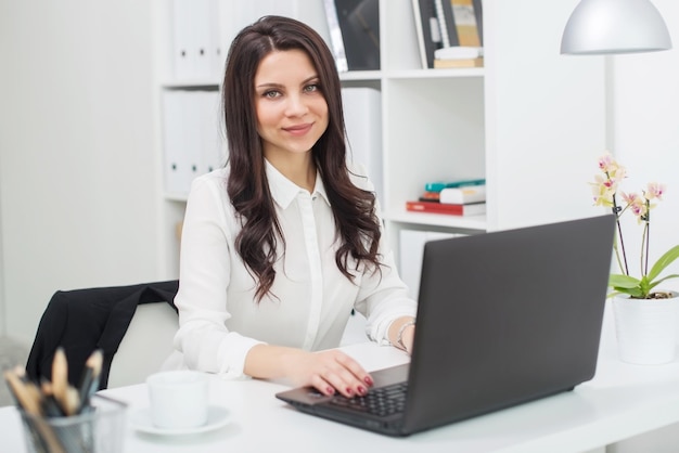 Business woman with notebook in office workplace