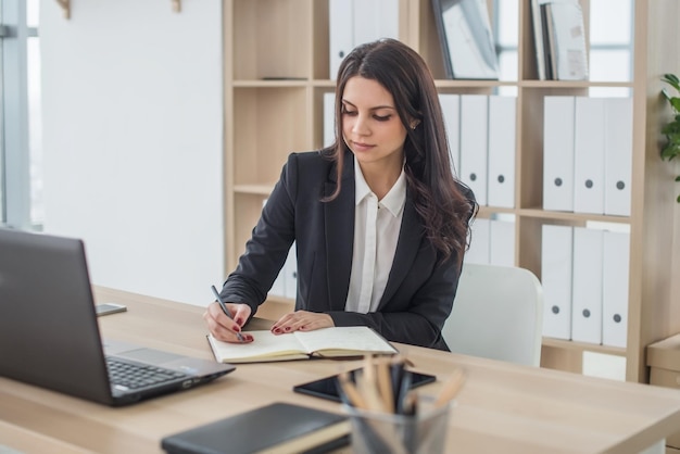 Business woman with notebook office workplace