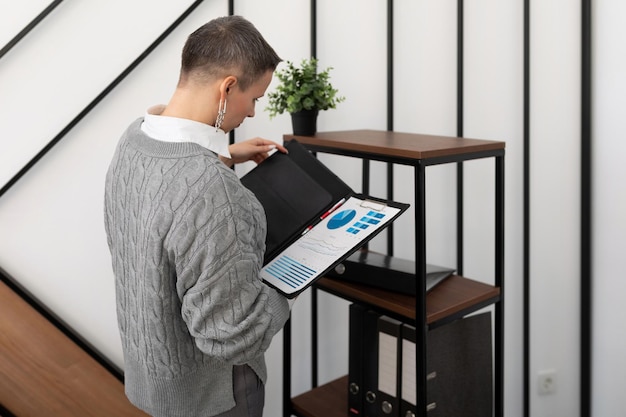 Business woman with a short haircut in the office with documents in her hands