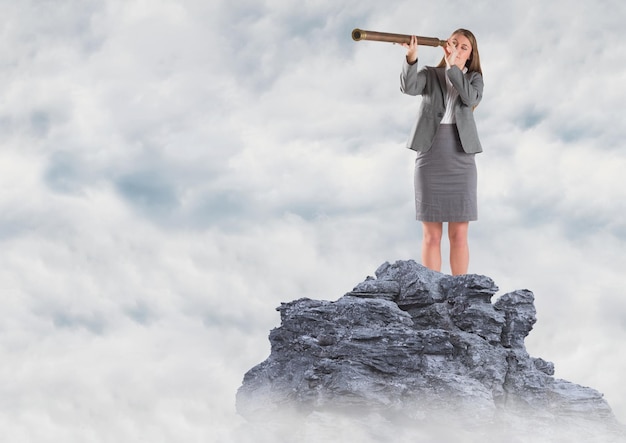 Photo business woman with telescope on mountain peak in the clouds