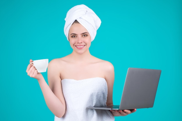 Business woman with towel on head with coffee working on laptop morning coffee portrait of smiling w