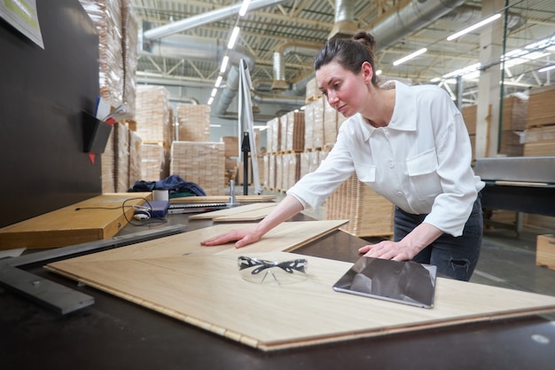 Business woman worker in the carpentry factory using tablet pc