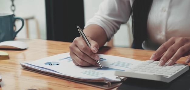 Business woman working in finance and accounting Analyze financial budget in the office