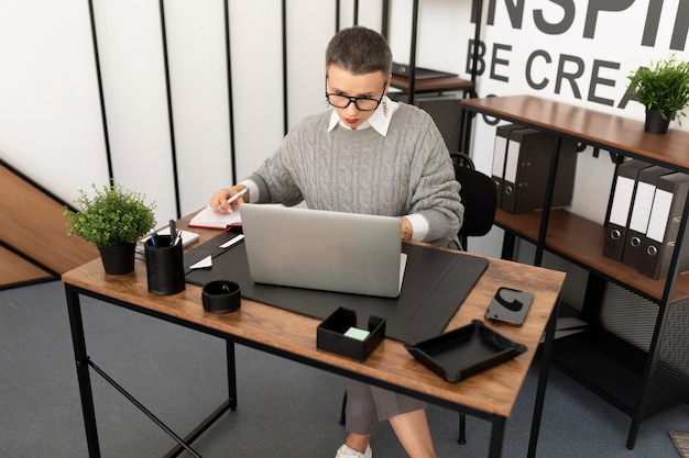 Business woman working in glasses at a laptop in the office