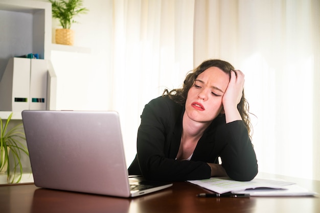 Business woman working at her computer and stressed out in the office Entrepreneur woman tired