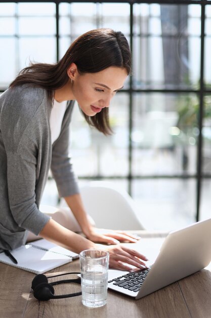 Business woman working on laptop computer in office