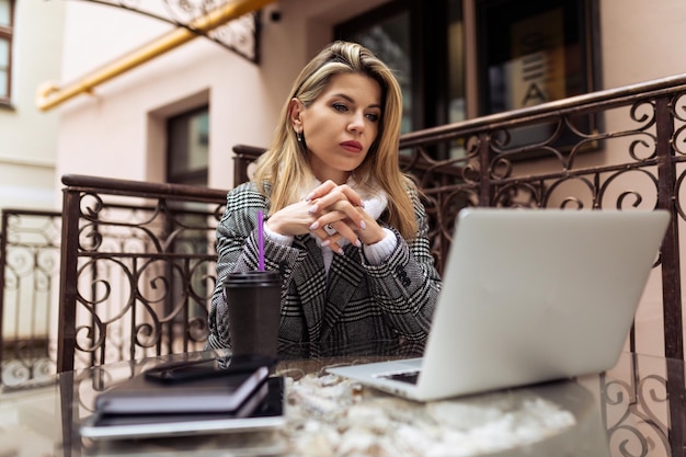 Business woman working remotely in the city on a laptop principles and rules of successful business