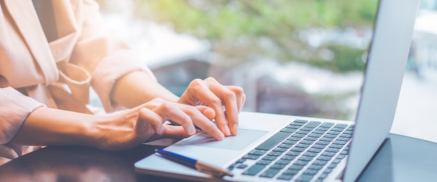 Business woman working with a laptop computer in the office.For web banner.