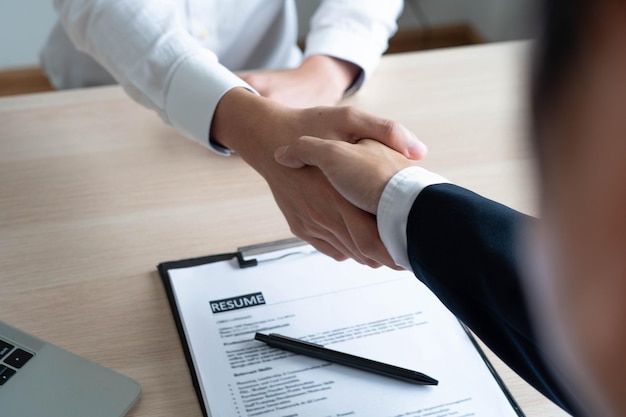 Business women and job seekers shake hands after agreeing to accept a job and approve it as an employee in the company Or a joint venture agreement between the two businessmen