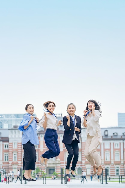 Business women of various ages who bounce vigorously