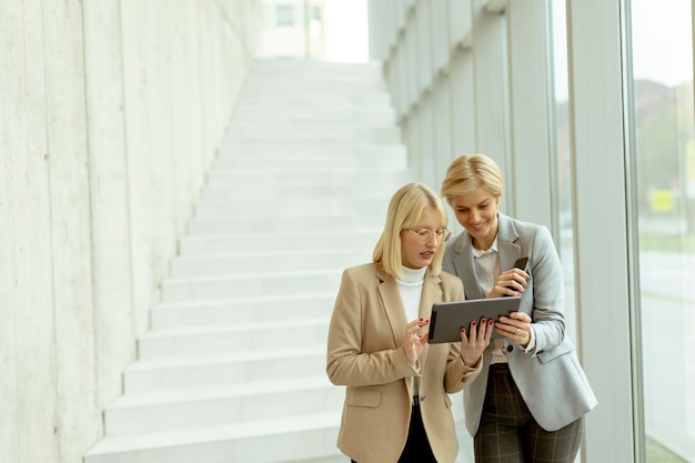 Business women walking in the office corridor