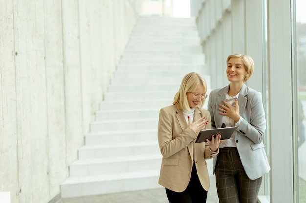 Business women walking in the office corridor