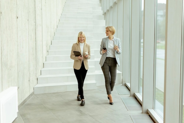 Business women walking in the office corridor