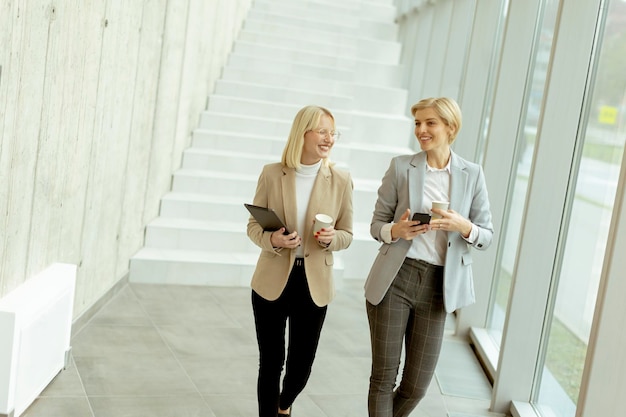 Business women walking in the office corridor