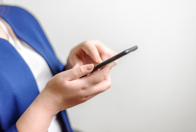 Business women with smartphone mobile on blurred background