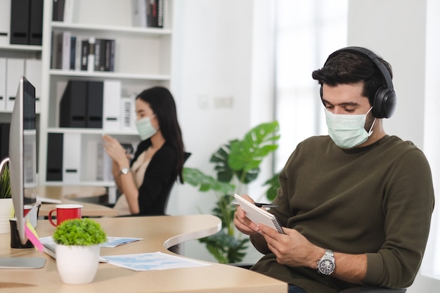 Business work in office with face mask social distancing quarantine during COVID19 affect