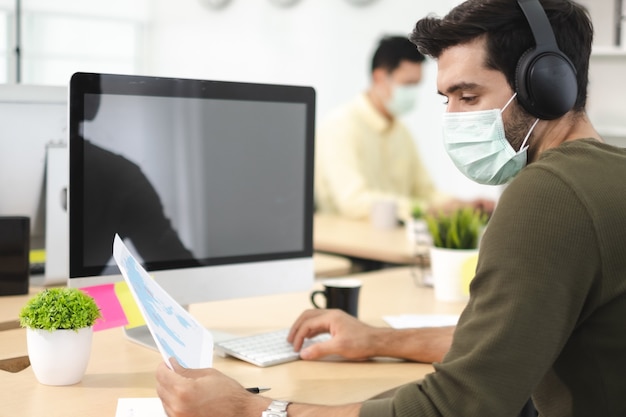 Business work in office with face mask social distancing quarantine during COVID19 affect