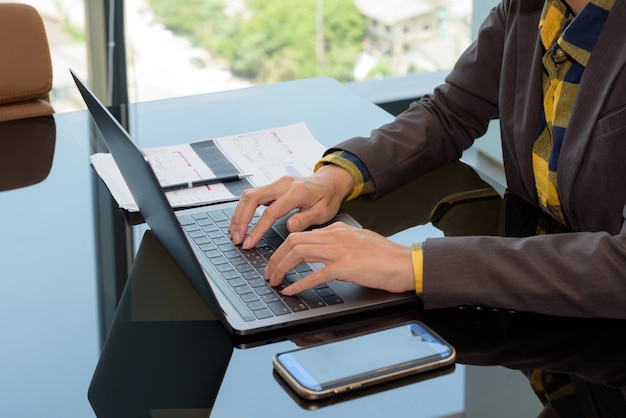 Business working at office : Close up hand of business women typing laptop computer on a table.