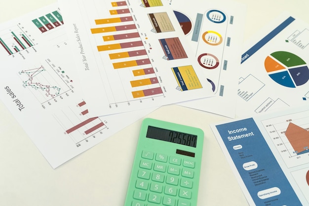 Business working paper with a diagram calculator pen on desk