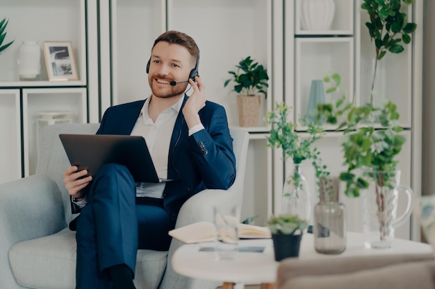 Businessman adjusting headset with his hand during online communication