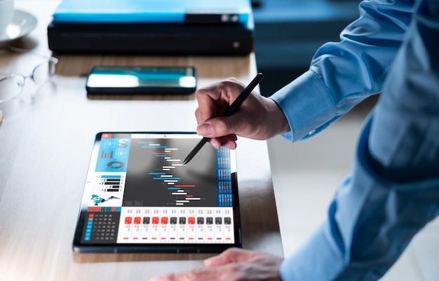 Businessman analyzing investment stock market and economic growth graph chart on tablet