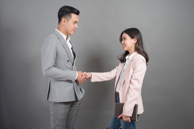 Businessman and businesswoman are shaking hands