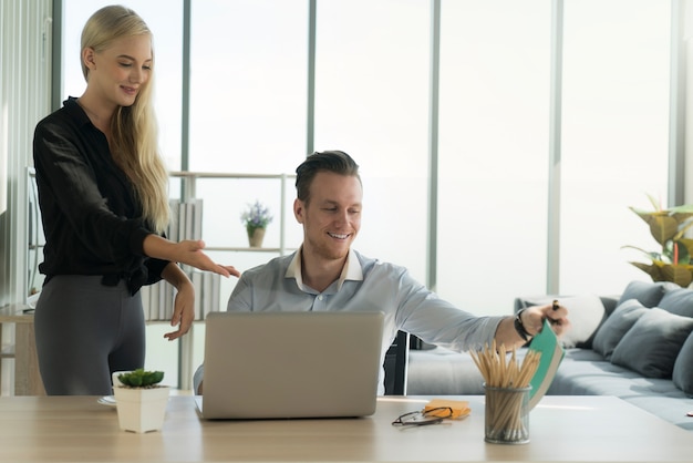 businessman and businesswoman working on laptop  with happiness smile face working at home concept