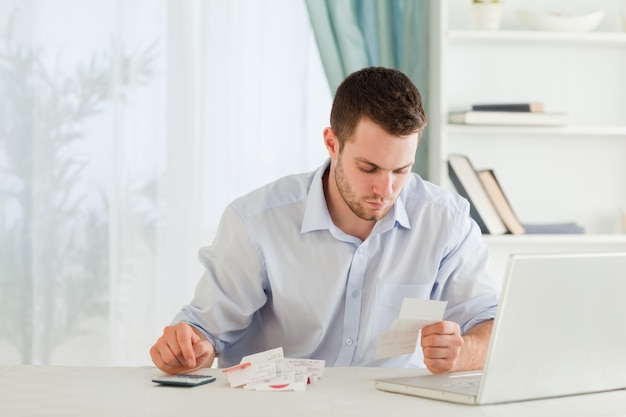 Businessman calculating his expenses