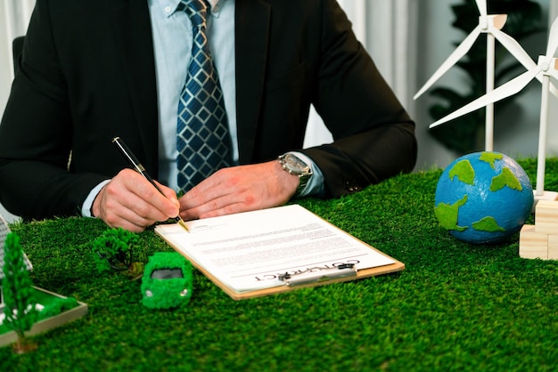 Businessman or CEO in office signing environmental regulation agreement to save Earth with sustainable energy utilization and CO2 reduction for greener future Quaint