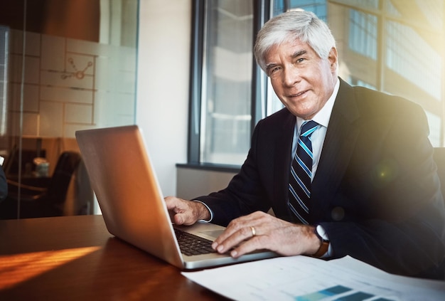 Photo businessman ceo and portrait with laptop in office for experience with smile for confidence in workplace advocate lawyer and law firm with manager or boss with senior pride and expert in career