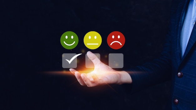 Businessman choosing happy smile face icon feedback rating and positive customer review experience satisfaction survey mental health assessment World mental health day concept