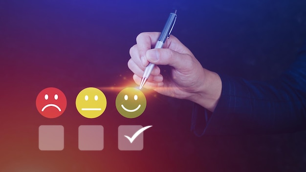 Businessman choosing happy smile face icon feedback rating and positive customer review experience satisfaction survey mental health assessment World mental health day concept