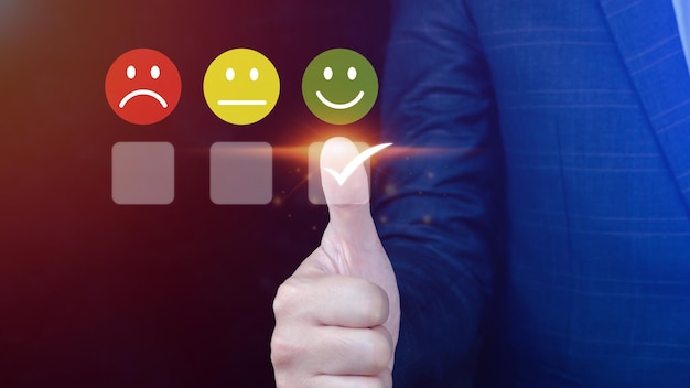 Businessman choosing happy smile face icon feedback rating and positive customer review experience satisfaction survey mental health assessment World mental health day concept