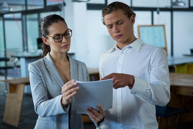 Businessman and a colleague discussing over document