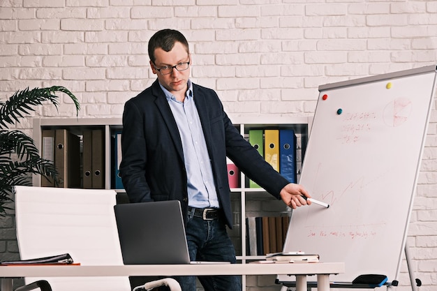 Businessman conducts a presentation online having a video conference serious man in glasses and a ja