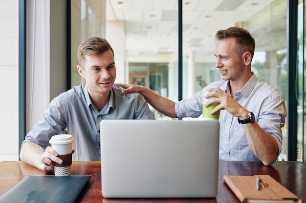 Businessman congratulating colleague