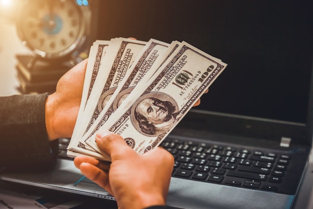 businessman counting dollar banknotes.