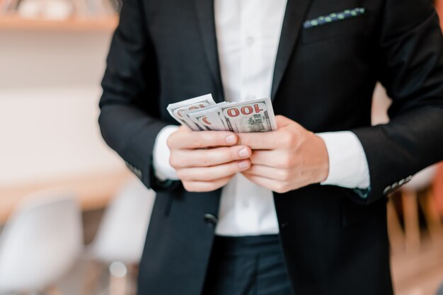 Businessman counting money dollar bills